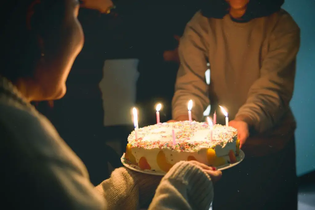 man handing over a cake